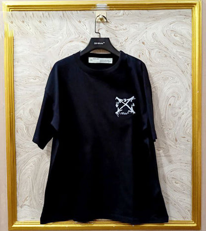 Black t-shirt with "Off-White™" logo on a hanger against a marble wall.