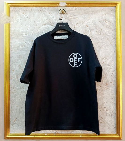 Black t-shirt with "Off-White™" logo on a hanger against a marble wall.